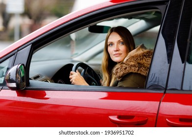 Young Attractive Woman With Happy Positive Expression, Being Satisfied With Unforgettable Journey By Car, Sits On Driver Seat. People, Driving, Transport Concept. Winter Ski Holiday By Car