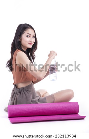 Young attractive woman holding a yoga mat. Isolated on white