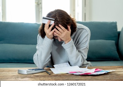 Young attractive woman looking stressed and worried with card payments and home finances accounting costs charges taxes and mortgage in paying bills financial problems and credit card debts concept.