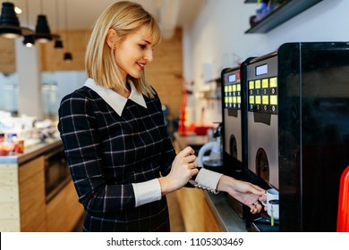 Young Attractive Woman Making A Coffee In An Office Cafeteria