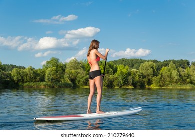 Young Attractive Woman On Stand Up Paddle Board In The Lake, SUP