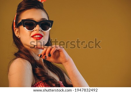Young attractive woman pin up style in coll sunglasses