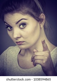 Young Attractive Woman Pointing Into Camera, Teenage Judging Someone. Studio Shot On Grey Background.