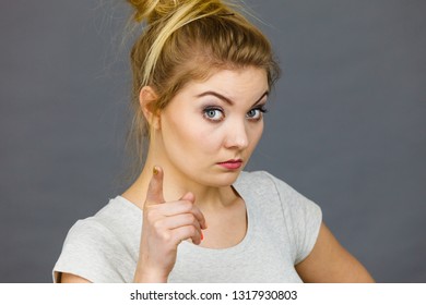 Young Attractive Woman Pointing Into Camera, Teenage Judging Someone. Studio Shot On Grey Background.