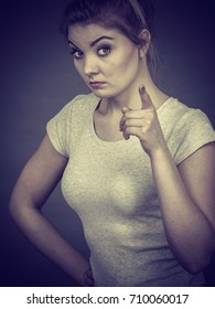 Young Attractive Woman Pointing Into Camera, Teenage Judging Someone. Studio Shot On Grey Background.