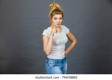 Young Attractive Woman Pointing Into Camera, Teenage Judging Someone. Studio Shot On Grey Background.