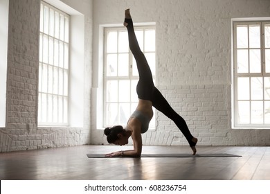 Young attractive woman practicing yoga, standing in One legged dolphin pose, working out, wearing sportswear bra and pants, full length, white loft studio background, side view. Weight loss concept - Shutterstock ID 608236754