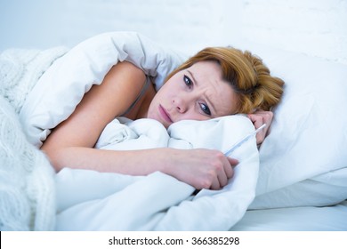 Young Attractive Woman In Sad And Depressed Face Expression With Eyes Wide Open Lying In Bed Looking Sick And Unable To Sleep Suffering Depression , Nightmares Or Insomnia Sleeping Disorder