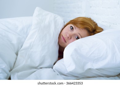 Young Attractive Woman In Sad And Depressed Face Expression With Eyes Wide Open Lying In Bed Looking Sick And Unable To Sleep Suffering Depression , Nightmares Or Insomnia Sleeping Disorder