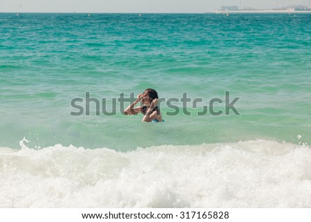 Young Attractive Woman Swimming In Ocean