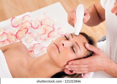 Young Attractive Woman Undergoes Microdermabrasion Therapy In Spa Setting