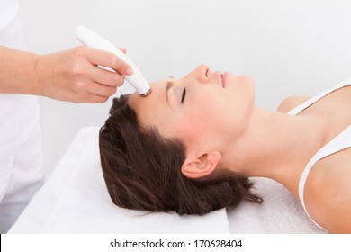 Young Attractive Woman Undergoes Microdermabrasion Therapy In Spa