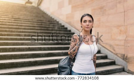 Young attractive woman visiting the Nationalgalerie Museum building. Berlin, Germany.