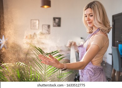 Young Attractive Woman Watering Plants In Home. Making Domestic Work