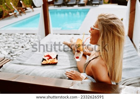 Young attractive women enjoy on a canopy by the pool