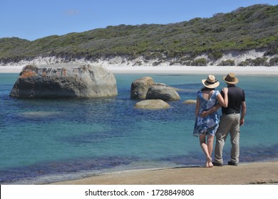 Young Australian Couple Looking At The Landscape View Of Greens Pool Beach With Boulders On The South Coast Of Western Australia Between Denmark And Walpole.