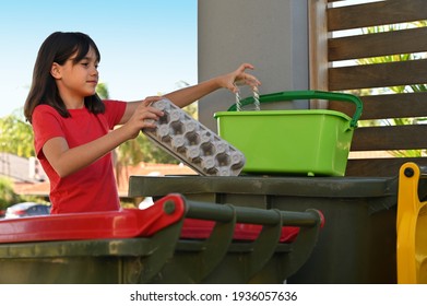 Young Australian Teenager Girl (female Age 10-11) Helping In House Chores Recycling Garbage In Australia. Real People. Copy Space