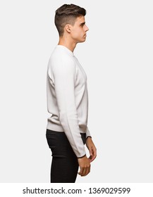 Young authentic man on the side looking to front