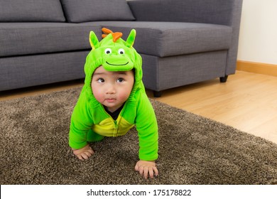 Young Baby Boy Dressed In Dinosaur