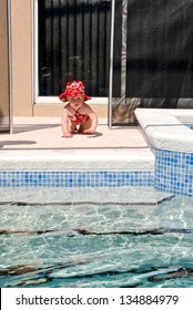 A Young Baby Crawls Through The Opening Of The Safety Fence Left Open. No Adults Appear To Be Near The Child As She Moves Toward The Swimming Pool.