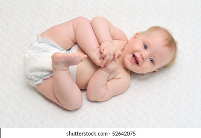 Young Baby Girl Playing With Her Feet.