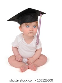 A young baby has on a graduation black cap with a tassel on a white isolated background. Use it for a school or education concept.