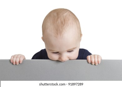 young baby holding blank grey cardboard. isolate on white background