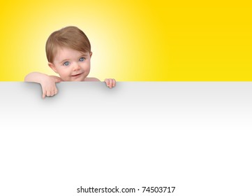 A young baby is holding a white isolated sign. Add your message in the blank copyspace.
