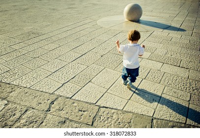 Young Baby Running Towards Stone Ball, Copy Space