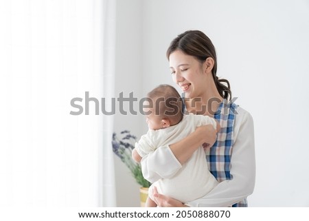 Young babysitter hugging a baby