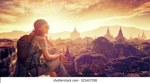Young backpacker enjoying a looking at sunset on Bagan, Myanmar Asia. Traveling along Asia, active lifestyle concept