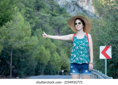 Young Backpacker Woman Waiting Auto Stop On The Road