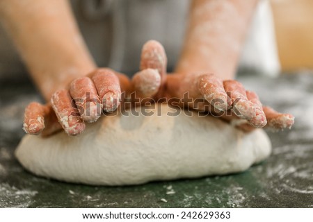 Young baker preparing artisan sourdough bread.