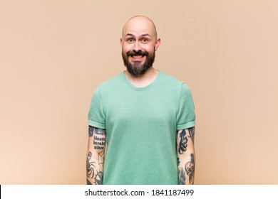 Young Bald And Bearded Man Looking Happy And Goofy With A Broad, Fun, Loony Smile And Eyes Wide Open