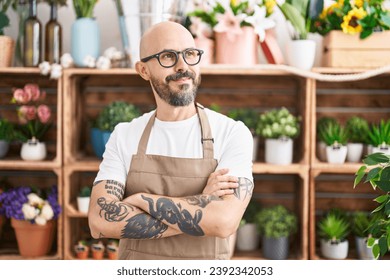 Young bald man florist smiling confident standing with arms crossed gesture at florist - Powered by Shutterstock