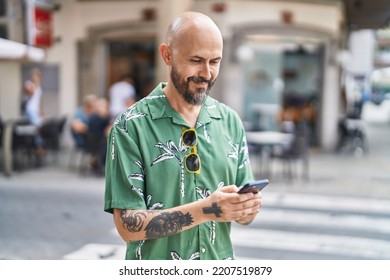 Young Bald Man Smiling Confident Using Smartphone At Street