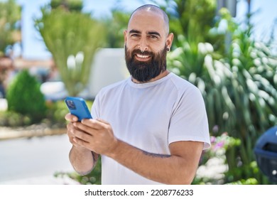 Young Bald Man Smiling Confident Using Smartphone At Park