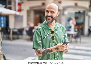 Young Bald Man Smiling Confident Using Smartphone At Street