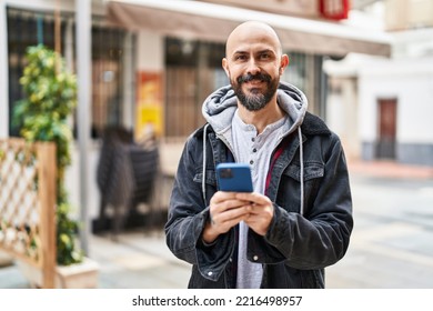 Young Bald Man Smiling Confident Using Smartphone At Street