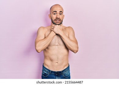 Young bald man standing shirtless shouting and suffocate because painful strangle. health problem. asphyxiate and suicide concept. 
