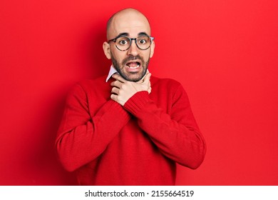 Young bald man wearing casual clothes and glasses shouting and suffocate because painful strangle. health problem. asphyxiate and suicide concept. 