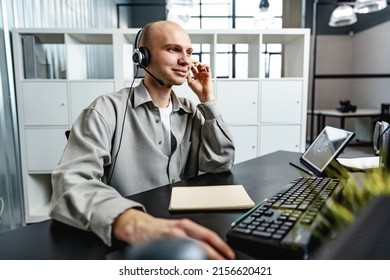 Young Bald Man Working In A Call Center Office