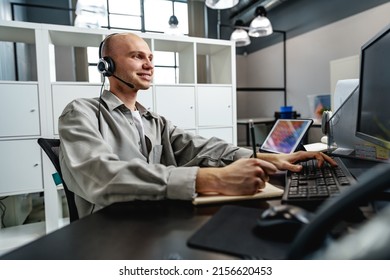 Young Bald Man Working In A Call Center Office