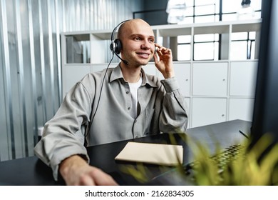 Young Bald Man Working In A Call Center Office