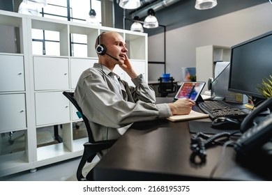 Young Bald Man Working In A Call Center Office