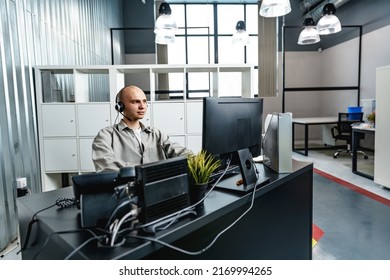 Young Bald Man Working In A Call Center Office