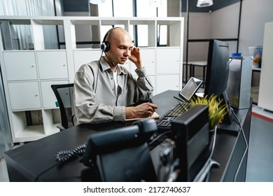 Young Bald Man Working In A Call Center Office