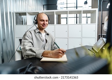 Young Bald Man Working In A Call Center Office