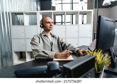 Young Bald Man Working In A Call Center Office