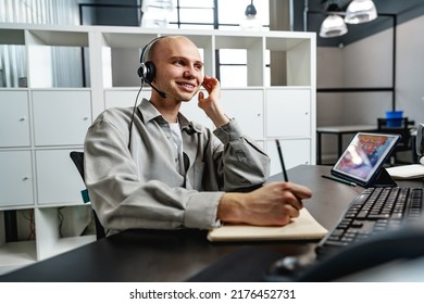 Young Bald Man Working In A Call Center Office